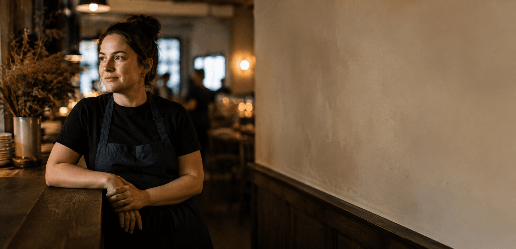 A hospitality worker taking a moment at their venue